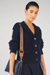 Profile view of model wearing the Oroton Heather Long Light Gold Webbing Strap in Navy/Cognac and 100% Jacquard webbing material for Women .