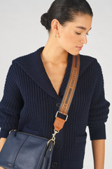 Profile view of model wearing the Oroton Heather Long Light Gold Webbing Strap in Navy/Cognac and 100% Jacquard webbing material for Women .