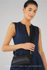 Profile view of model wearing the Oroton Harvey Baguette Crossbody in Black and Smooth leather for Women .