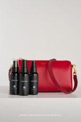 Profile view of model wearing the Oroton Harvey Baguette Crossbody in DARK RUBY and Premium smooth leather for Women .