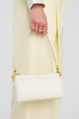 Profile view of model wearing the Oroton Harvey Baguette Crossbody in Cream and Premium smooth leather for Women .