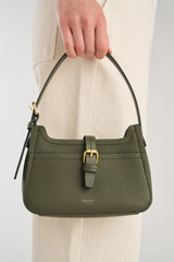Profile view of model wearing the Oroton Dylan Mini Baguette Crossbody in CACTUS and Premium pebble leather for Women .