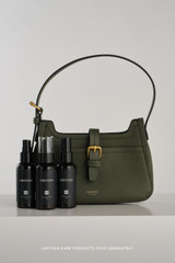 Profile view of model wearing the Oroton Dylan Mini Baguette Crossbody in CACTUS and Premium pebble leather for Women .