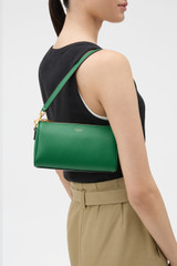 Profile view of model wearing the Oroton Harvey Baguette Crossbody in CROCODILE and Premium smooth leather for Women .