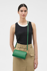 Profile view of model wearing the Oroton Harvey Baguette Crossbody in CROCODILE and Premium smooth leather for Women .