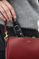 Profile view of model wearing the Oroton Harvey Baguette Crossbody in BERRY and Premium smooth leather for Women .