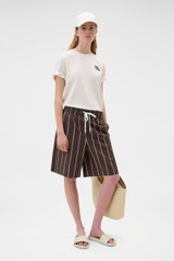 Profile view of model wearing the Oroton Maggie Graphic Tee in Calico and 100% cotton single jersey fabric for Women .