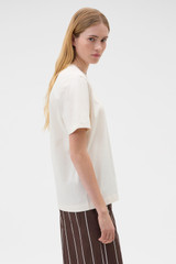 Profile view of model wearing the Oroton Maggie Graphic Tee in Calico and 100% cotton single jersey fabric for Women .