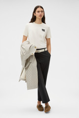 Profile view of model wearing the Oroton Maggie Graphic Tee in Calico and 100% cotton single jersey fabric for Women .