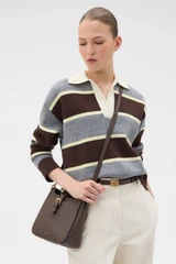 Profile view of model wearing the Oroton Dylan Small Bucket in Coffee Bean and Premium pebble leather for Women .