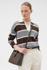 Profile view of model wearing the Oroton Dylan Small Bucket in Coffee Bean and Premium pebble leather for Women .