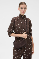 Profile view of model wearing the Oroton Cali Suede Baguette in Dark Chocolate and Premium cow suede leather for Women .