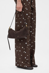 Profile view of model wearing the Oroton Cali Suede Baguette in Dark Chocolate and Premium cow suede leather for Women .