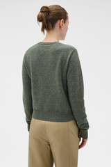 Profile view of model wearing the Oroton Wrap Scarf Knit in Soft Khaki and 100% mid-gauge merino wool fabric for Women .