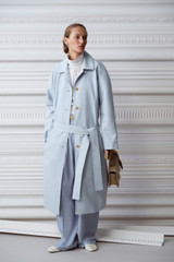 Profile view of model wearing the Oroton Essential Mac in Soft Smoke Blue and 77% cotton and 23% linen blend fabric for Women .