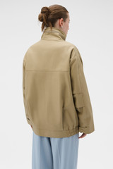 Profile view of model wearing the Oroton Utility Parka in Haystack and 100% cotton fabric for Women .