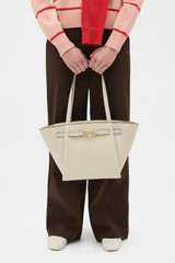 Profile view of model wearing the Oroton Juliette Medium Tote in Ecru and Premium pebble leather for Women .