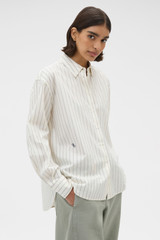 Profile view of model wearing the Oroton Dobby Stripe Shirt in Whipped Cream and 100% cotton fabric for Women .