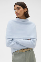 Profile view of model wearing the Oroton Cashmere Blend Scarf in Soft Blue and 70% ultra fine merino wool and 30% cashmere blend fabric for Women .