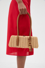 Profile view of model wearing the Oroton Louisa Wicker Bag in Natural/Cognac and Premium smooth cow leather for Women .