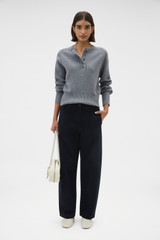 Profile view of model wearing the Oroton Rib Knit Henley in Grey Marle and 100% supersoft merino wool fabric for Women .