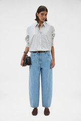 Profile view of model wearing the Oroton Soft Stripe Shirt in Soft Blue and 100% cotton fabric for Women .