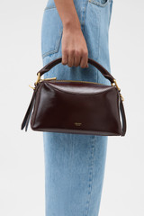 Profile view of model wearing the Oroton Lewis Crackle Day Bag in Copper and Premium smooth leather for Women .
