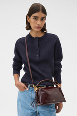 Profile view of model wearing the Oroton Lewis Crackle Day Bag in Copper and Premium smooth leather for Women .