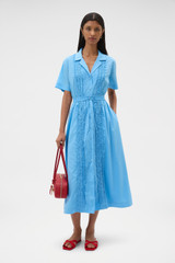 Profile view of model wearing the Oroton Ruffle Detail Shirt Dress in Sea Blue and 100% cotton voile fabric for Women .