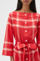 Profile view of model wearing the Oroton Vintage Check Tunic Dress in Ribbon Red and 100% midweight linen fabric for Women .