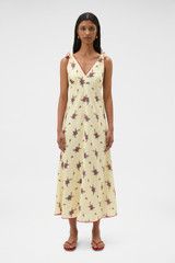 Profile view of model wearing the Oroton Wallpaper Floral Print Dress in Lemon and 100% midweight linen fabric for Women .