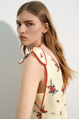Profile view of model wearing the Oroton Wallpaper Floral Print Dress in Lemon and 100% midweight linen fabric for Women .