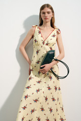 Profile view of model wearing the Oroton Wallpaper Floral Print Dress in Lemon and 100% midweight linen fabric for Women .
