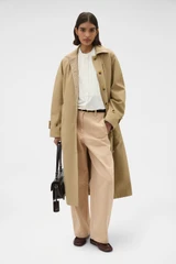 Profile view of model wearing the Oroton Reversible Check Mac in Camel and 100% soft cotton fabric for Women .
