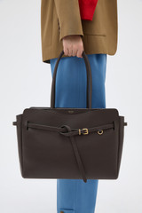 Profile view of model wearing the Oroton Cleo Smooth Work Tote in Dark Chocolate and Premium smooth leather for Women .