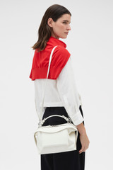 Profile view of model wearing the Oroton Mica Smooth Bowler in Warm White and Premium smooth leather for Women .
