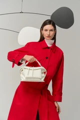 Profile view of model wearing the Oroton Mica Smooth Bowler in Warm White and Premium smooth leather for Women .
