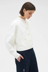 Profile view of model wearing the Oroton Curved Sleeve Jacket in Antique White and 100% cotton fabric for Women .