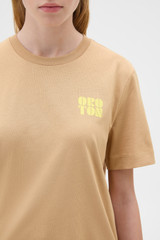 Profile view of model wearing the Oroton Maggie Graphic Tee in Praline and 100% cotton single jersey fabric for Women .