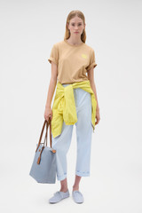 Profile view of model wearing the Oroton Maggie Graphic Tee in Praline and 100% cotton single jersey fabric for Women .