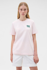 Profile view of model wearing the Oroton Maggie Graphic Tee in Perfect Pink and 100% cotton single jersey fabric for Women .