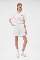 Profile view of model wearing the Oroton Maggie Graphic Tee in Perfect Pink and 100% cotton single jersey fabric for Women .