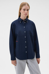 Profile view of model wearing the Oroton Oxford Shirt in North Sea and 100% cotton fabric for Women .