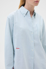 Profile view of model wearing the Oroton Oxford Stripe Shirt in Ivy Green and 100% cotton fabric for Women .