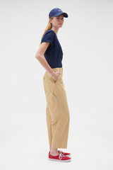 Profile view of model wearing the Oroton Arlo Carpenter Chino in Praline and 100% cotton fabric for Women .