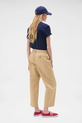 Profile view of model wearing the Oroton Arlo Carpenter Chino in Praline and 100% cotton fabric for Women .