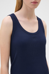 Profile view of model wearing the Oroton Scoop Neck Tank in North Sea and 92% cotton and 8% spandex blend fabric for Women .