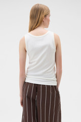 Profile view of model wearing the Oroton Scoop Neck Tank in Antique White and 92% cotton and 8% spandex blend fabric for Women .