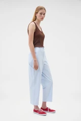 Profile view of model wearing the Oroton Arlo Carpenter Chino in Pale Blue and 100% cotton fabric for Women .