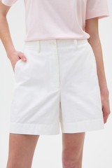 Profile view of model wearing the Oroton Flat Front Carpenter Short in Antique White and 100% cotton fabric for Women .
